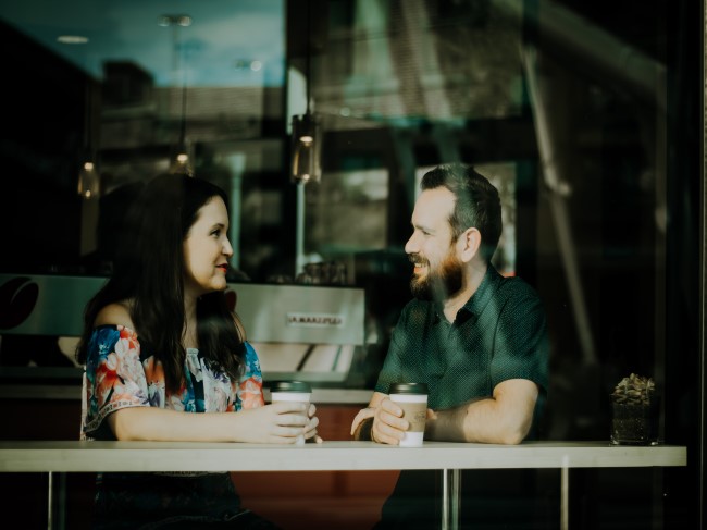 Two people in a cafe talking