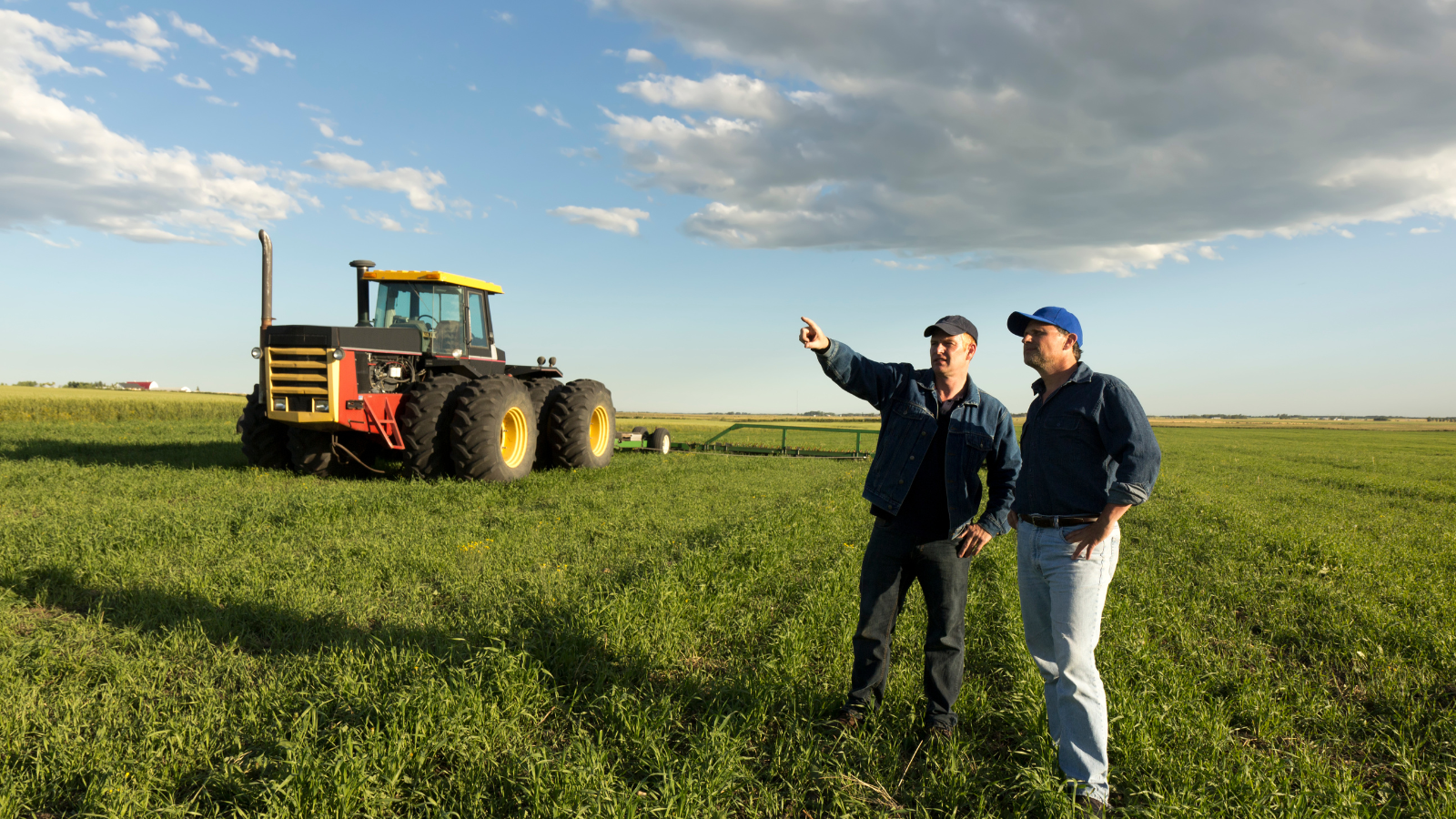 Farmers in field with tractor